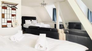 a room with two beds and a mirror at Guesthouse fürDich in Zurich