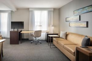 a living room with a couch and a desk at Residence Inn by Marriott Orlando Downtown in Orlando