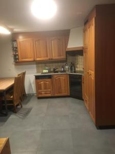 a kitchen with wooden cabinets and a table and a sink at Wohnung 17, Marico in Zermatt