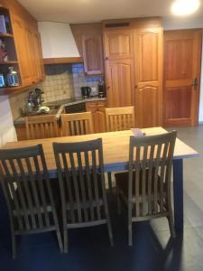 a kitchen with a wooden table and two chairs at Wohnung 17, Marico in Zermatt