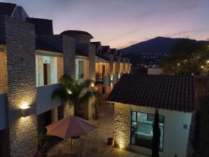 a building with an umbrella in front of it at Mirador Johya Hotel in Bernal