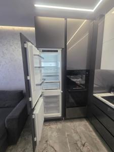 an empty refrigerator with its door open in a kitchen at arena sunrise in Burgas