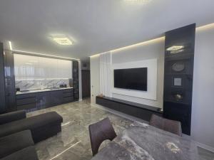 a living room with a television on a wall at arena sunrise in Burgas