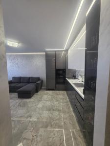 a large living room with a couch and a sink at arena sunrise in Burgas +24 photos
