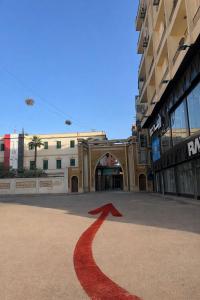a red arrow on a street in front of a building at Grand Duplex in Aswan +14 photos