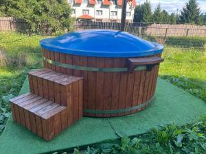 a large wooden tub with a blue top at ADAM-OASIS in Borzont