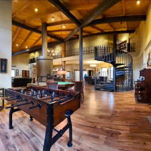 a living room with a pool table and a staircase at Cabaña Santa Fe in Mesa de las Tablas