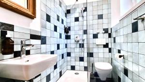 a bathroom with a sink and a toilet at Guesthouse fürDich in Zurich +58 photos