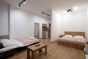 a room with two beds and a table in it at Tashev Apartments in Veles +46 photos