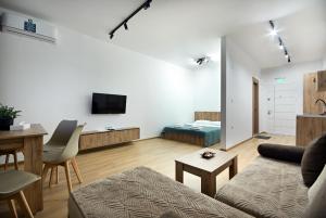 a living room with a couch and a table at Tashev Apartments in Veles