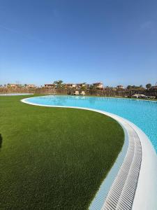 an overhead view of a swimming pool with green grass at Casa Encanto in Lajares