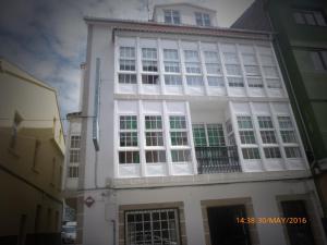 a white building with a lot of windows at Hostal O Choyo II in Ferrol