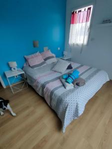 a bedroom with a bed with a dog laying on the floor at chambre Chez sylvie in Allaire
