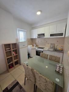 a kitchen with white cabinets and a green counter top at Villa Nela in Tivat