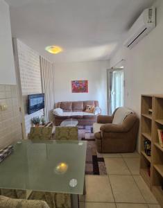 a living room with a couch and a table at Villa Nela in Tivat