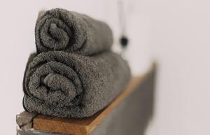 a pile of towels sitting on top of a shelf at L'Arco Trieste studio living 1 in Trieste +14 photos