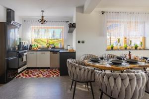 a kitchen with a table and chairs in a room at Osada Poronin in Poronin