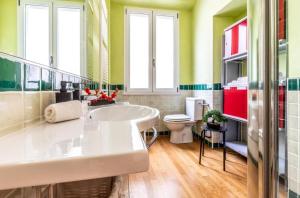 a bathroom with a tub and a toilet at I Maltesi apartment in Sassari +13 photos