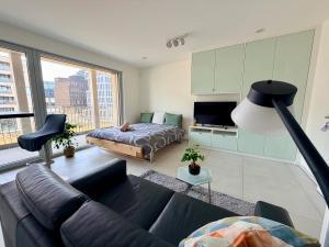 a living room with a couch and a bed at Urban Nest Studio - Cloche d'Or in Luxembourg
