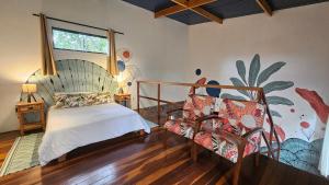 a bedroom with a bed and a mural on the wall at Casas Vila Encantada Refúgio, conforto e natureza, apenas 2 min da avenida in Alto Paraíso de Goiás