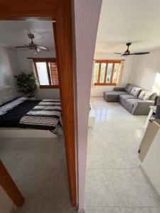 a living room with a couch and a mirror at Club aldeas de taray in San Javier +19 photos