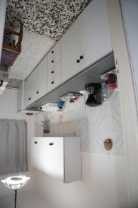 a kitchen with white cabinets and a ceiling at Trikala Apartments in Tríkala