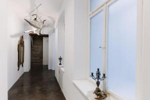 a hallway with white walls and a large window at L'arco Trieste studio living 2 in Trieste +20 photos