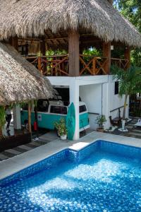 a resort with a swimming pool in front of a building at The Beach Break Hotel El Zonte in El Zonte