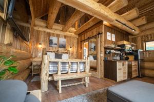 a log cabin bedroom with a bed and a desk at Boulder Mountain Resort in Revelstoke