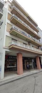 a tall building with balconies on the side of it at Parastaseis City Flat Central in Patra