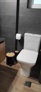a bathroom with a white toilet in a room at Parastaseis City Flat Central in Patra +82 photos