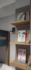 a book shelf with some books and books at Parastaseis City Flat Central in Patra