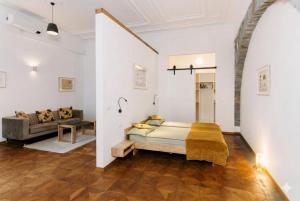 a bedroom with a bed and a couch in a room at L'arco Trieste studio living 2 in Trieste