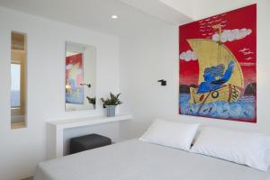 a bedroom with a bed and a painting on the wall at Villa Apollo in Kionia +20 photos
