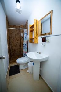 a bathroom with a sink and a toilet and a shower at The Beach Break Hotel El Zonte in El Zonte +35 photos