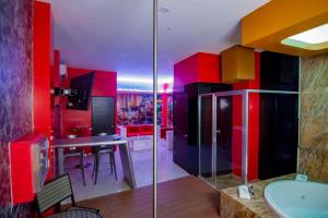 a bathroom with red and yellow cabinets and a sink at COSMOPOLITAN Autohotel in Boca del Río