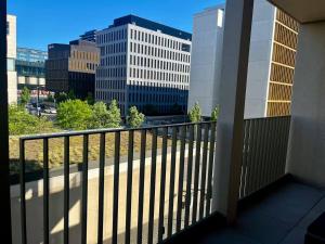 a balcony with a view of a city at Urban Nest Studio - Cloche d'Or in Luxembourg +2 photos
