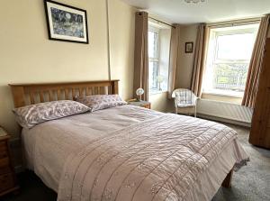 a bedroom with a bed and a window at Ffyllon Fawr in Henfynyw Upper