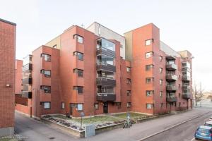 a row of brick apartment buildings on a street at Happy house katajanokka in Helsinki