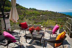 a patio with chairs and tables with a view of the ocean at Il Giardino di Fe in Sori