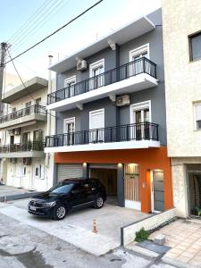 a black car parked in front of a building at Midway Point Apts in Heraklio