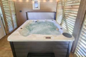 a jacuzzi tub in a room with windows at 7916 - Hatteras Vista in Hatteras