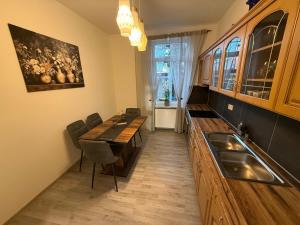 a kitchen with a sink and a table with chairs at Andoniev in Salzelmen