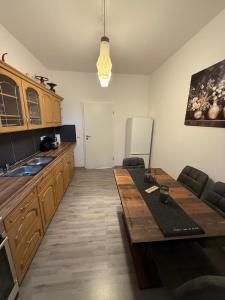 a kitchen with a wooden table in a room at Andoniev in Salzelmen +7 photos