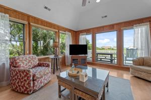 a living room with a couch and a tv at 2444 - Sea Forever in Duck