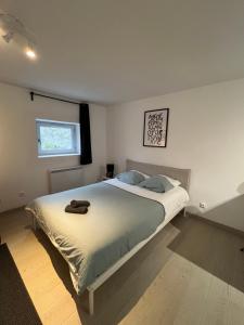 a bedroom with a large bed with towels on it at Apartment avec cours in Bonny-sur-Loire
