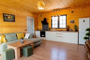 a living room with a couch and a table at Natural cottage in Saguramo