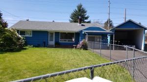 a blue house with a fence in front of it at Gary's Place in Springfield