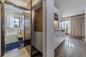 a bathroom with a shower and a toilet and a sink at Haus Hammerer in Ellmau +29 photos
