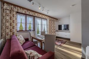 a living room with a purple couch and a table at Haus Hammerer in Ellmau